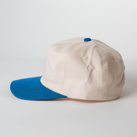 Vintage Style Hat Cerulean Blue and Natural - Beige cap with blue brim on a light gray background