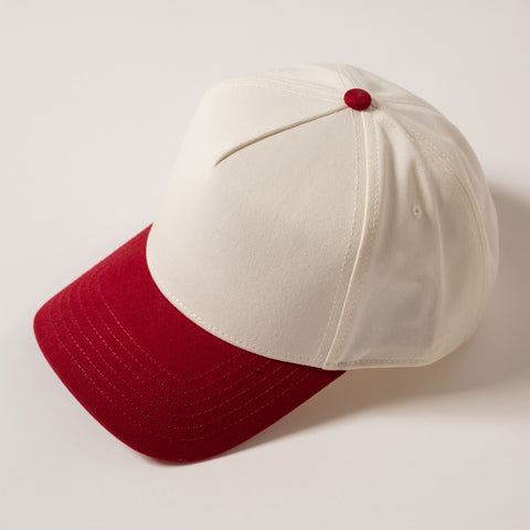 White and red baseball cap on a light gray background
