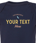 Detail shot of the coastal style baby onesie that reads "customizable your text here"