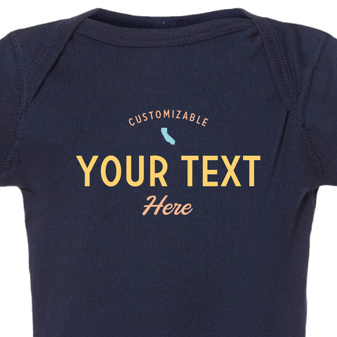 Detail shot of the coastal style baby onesie that reads "customizable your text here"