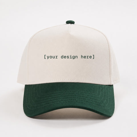 White and green cap with 'your design here' text on a white background