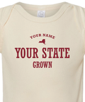 Detail shot of custom baby onesie reading "your name, your state, grown" and a US state silhouette